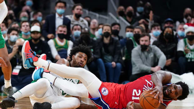 Dec 20, 2021; Boston, Massachusetts, USA; Philadelphia 76ers center Joel Embiid (21) and Boston Celtics guard Marcus Smart (36) work for the ball in the second half at TD Garden. Mandatory Credit: David Butler II-USA TODAY Sports