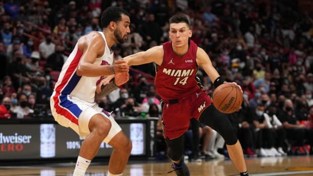 Dec 23, 2021; Miami, Florida, USA; Miami Heat guard Tyler Herro (14) drives the ball around Detroit Pistons forward Trey Lyles (8) during the second half at FTX Arena. Mandatory Credit: Jasen Vinlove-USA TODAY Sports