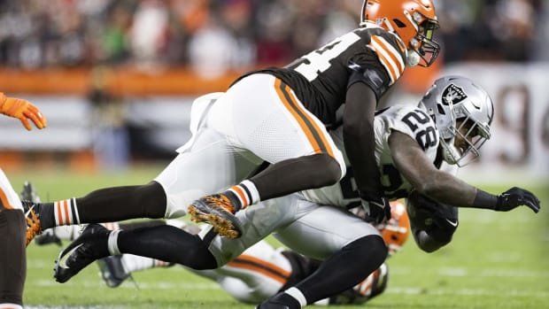 Dec 20, 2021; Cleveland, Ohio, USA; Cleveland Browns outside linebacker Sione Takitaki (44) tackles Las Vegas Raiders running back Josh Jacobs (28) during the second quarter at FirstEnergy Stadium. Mandatory Credit: Scott Galvin-USA TODAY Sports