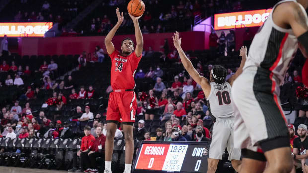 Dec 29, 2021; Athens, Georgia, USA; Gardner Webb Runnin Bulldogs forward Ludovic Dufeal (24) shoots over Georgia Bulldogs guard Aaron Cook (10) during the first half at Stegeman Coliseum. Mandatory Credit: Dale Zanine-USA TODAY Sports