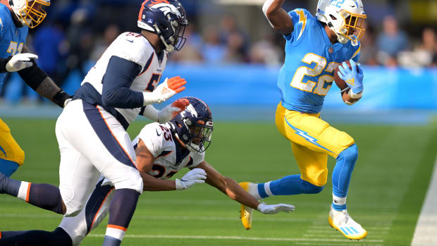 Jan 2, 2022; Inglewood, California, USA; Los Angeles Chargers running back Justin Jackson (22) gains a first down as he is chased by Denver Broncos cornerback Kyle Fuller (23) in the first quarter of the game at SoFi Stadium. Mandatory Credit: Jayne Kamin-Oncea-USA TODAY Sports