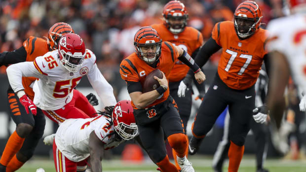 Jan 2, 2022; Cincinnati, Ohio, USA; Cincinnati Bengals quarterback Joe Burrow (9) runs with the ball against Kansas City Chiefs running back Elijah McGuire (24) in the second half at Paul Brown Stadium. Mandatory Credit: Katie Stratman-USA TODAY Sports