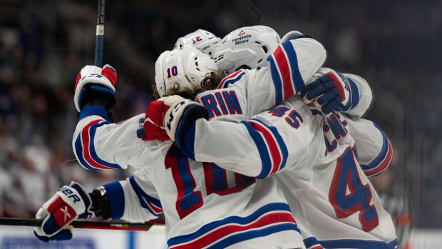 Jan 13, 2022; San Jose, California, USA; New York Rangers defenseman Braden Schneider (45) celebrates with left wing Artemi Panarin (10) and defenseman Braden Schneider (45) after scoring a goal during the third period against the San Jose Sharks at SAP Center at San Jose. Mandatory Credit: Stan Szeto-USA TODAY Sports