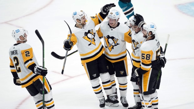 Jan 15, 2022; San Jose, California, USA; Pittsburgh Penguins left wing Jake Guentzel (59) celebrates with teammates after scoring a goal in overtime against the San Jose Sharks at SAP Center at San Jose. Mandatory Credit: Darren Yamashita-USA TODAY Sports