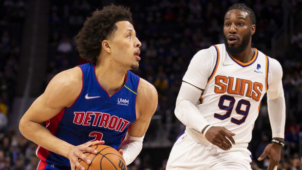 Jan 16, 2022; Detroit, Michigan, USA; Detroit Pistons guard Cade Cunningham (2) gets defended by Phoenix Suns forward Jae Crowder (99) during the second quarter at Little Caesars Arena. Mandatory Credit: Raj Mehta-USA TODAY Sports