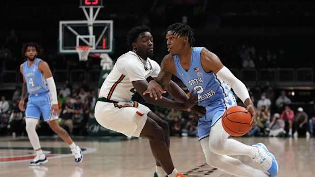 Jan 18, 2022; Coral Gables, Florida, USA; North Carolina Tar Heels guard Caleb Love (2) drives the ball around Miami Hurricanes guard Bensley Joseph (4) during the first half at Watsco Center. Mandatory Credit: Jasen Vinlove-USA TODAY Sports