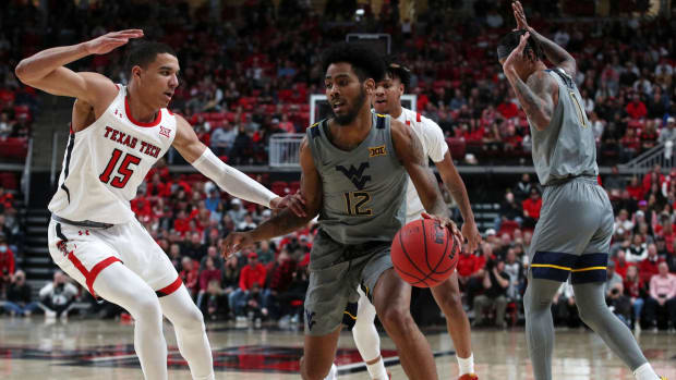 Jan 22, 2022; Lubbock, Texas, USA; West Virginia Mountaineers guard Taz Sherman (12) dribbles the ball against Texas Tech Red Raiders guard Kevin McCullar (15) in the second half at United Supermarkets Arena.