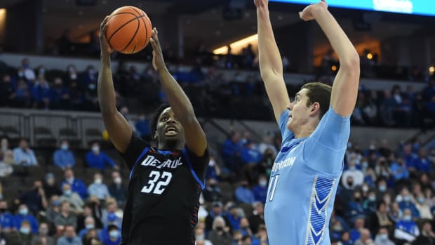 Jan 22, 2022; Omaha, Nebraska, USA; DePaul Blue Demons forward David Jones (32) drives on Creighton Bluejays center Ryan Kalkbrenner (11) in the first half at CHI Health Center Omaha. Mandatory Credit: Steven Branscombe-USA TODAY Sports