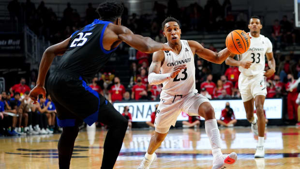 Cincinnati Bearcats guard Mika Adams-Woods (23) drives to the basket as Tulsa Golden Hurricane forward Rey Idowu (25) defends in the second half of an NCAA men's college basketball game, Thursday, Jan. 20, 2022, at Fifth Third Arena in Cincinnati. Tulsa Golden Hurricane At Cincinnati Bearcats Basketball Jan 20