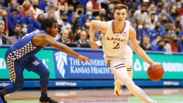 Kansas junior guard Christian Braun (2) dribbles aroiund Kentucky during the second half of Saturday's game inside Allen Fieldhouse.