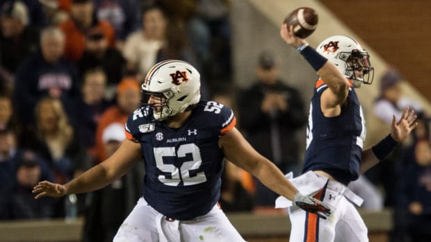 Auburn offensive lineman Nick Brahms (52) protects quarterback Bo Nix (10) as he throws the ball at Jordan-Hare Stadium in Auburn, Ala., on Saturday, Nov. 2, 2019. Auburn defeated Ole Miss 20-14. Jc Auburnolemiss 88