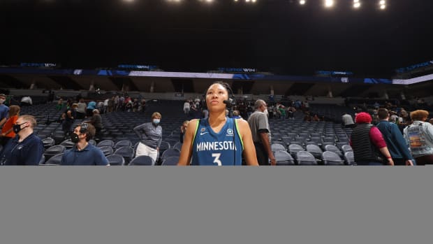 Aerial Powers standing on the court wearing a headset