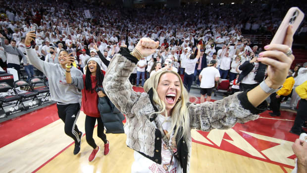 An Arkansas student rushes the court after the Razorbacks upset Auburn at Bud Walton Arena.