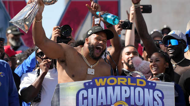 Feb 16, 2022; Los Angeles, CA, USA; Los Angeles Rams defensive end Aaron Donald holds the Vince Lombardi trophy during the Super Bowl LVI championship rally at the Los Angeles Memorial Coliseum. Mandatory Credit: Kirby Lee-USA TODAY Sports