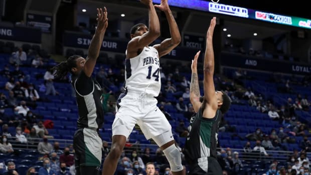 Dec 8, 2021; University Park, Pennsylvania, USA; Penn State Nittany Lions forward Jalanni White (14) shoots the ball as Wagner Seahawks forward Raekwon Rogers (32) and guard Elijah Ford (4) defend during the first half at Bryce Jordan Center. Mandatory Credit: Matthew OHaren-USA TODAY Sports