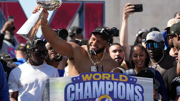 Feb 16, 2022; Los Angeles, CA, USA; Los Angeles Rams defensive end Aaron Donald holds the Vince Lombardi trophy during the Super Bowl LVI championship rally at the Los Angeles Memorial Coliseum. Mandatory Credit: Kirby Lee-USA TODAY Sports