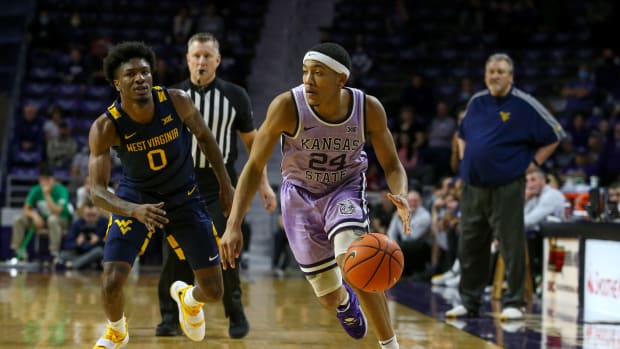 Feb 14, 2022; Manhattan, Kansas, USA; Kansas State Wildcats guard Nijel Pack (24) dribbles past West Virginia Mountaineers guard Kedrian Johnson (0) during the second half at Bramlage Coliseum. Mandatory Credit: Scott Sewell-USA TODAY Sports