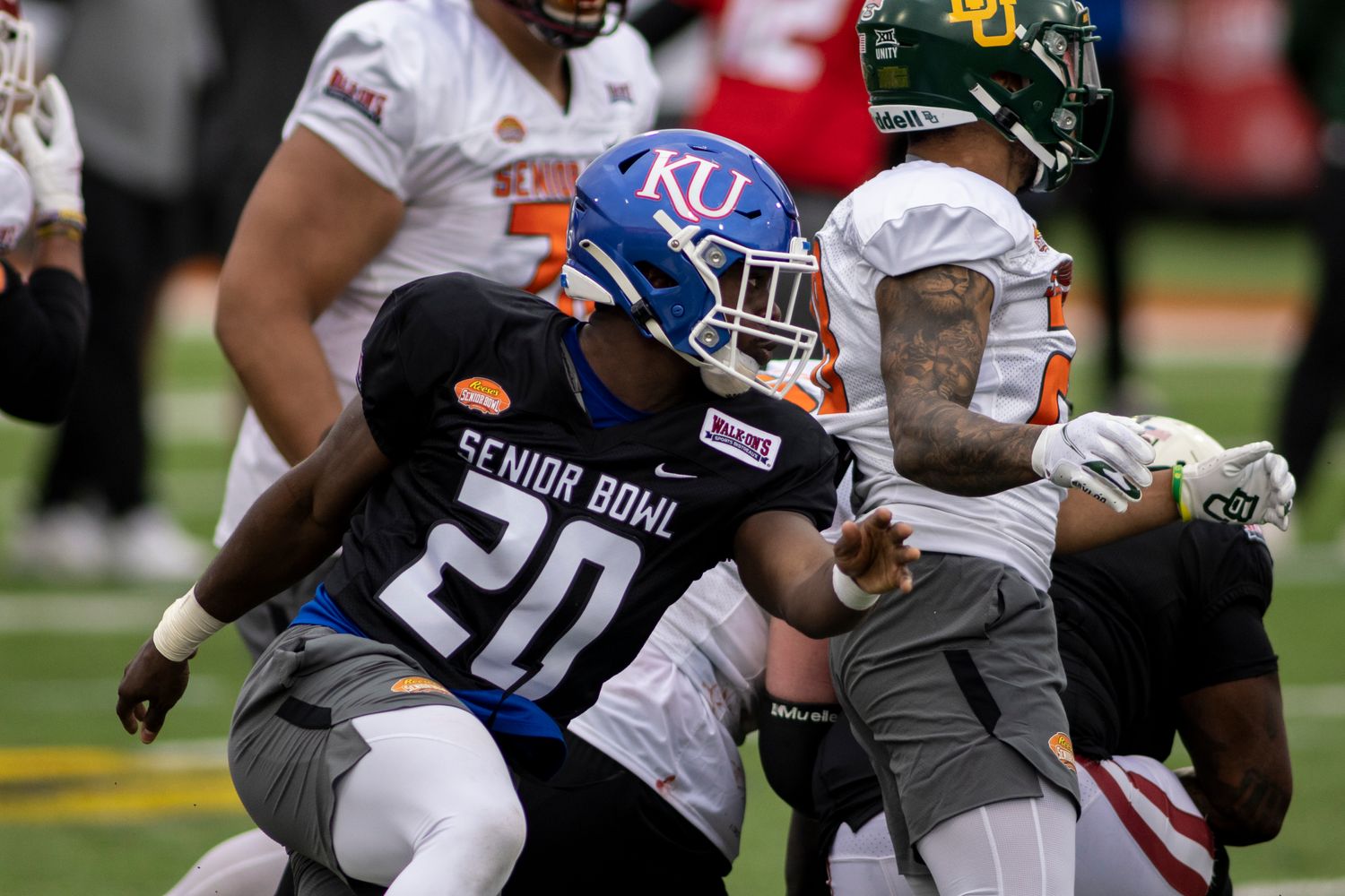 Feb 1, 2022; Mobile, AL, USA; National linebacker Kyron Johnson of Kansas (20) pursues a play during National practice for the 2022 Senior Bowl at Hancock Whitney Stadium. Mandatory Credit: Vasha Hunt-USA TODAY Sports
