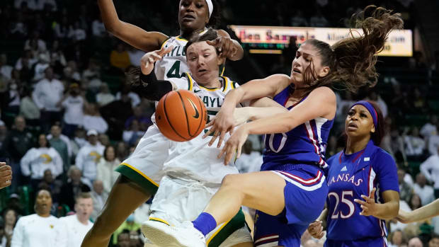Feb 26, 2022; Waco, Texas, USA; Baylor Lady Bears forward Caitlin Bickle (51) and Kansas Jayhawks forward Ioanna Chatzileonti (10) fight for a loose ball during the second half at Ferrell Center. Mandatory Credit: Chris Jones-USA TODAY Sports