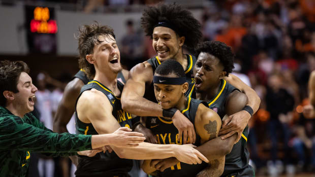 Feb 21, 2022; Stillwater, Oklahoma, USA; Baylor Bears teammates celebrate guard James Akinjo (11) pull up jumper to win the game against the Oklahoma State Cowboys at Gallagher-Iba Arena. Mandatory Credit: Rob Ferguson-USA TODAY Sports