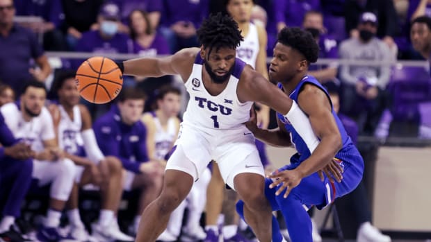 Mar 1, 2022; Fort Worth, Texas, USA; TCU Horned Frogs guard Mike Miles (1) dribbles as Kansas Jayhawks guard Joseph Yesufu (1) defends during the second half at Ed and Rae Schollmaier Arena. Mandatory Credit: Kevin Jairaj-USA TODAY Sports