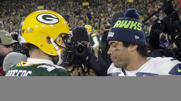 Aaron Rodgers and Russell Wilson meet at midfield.