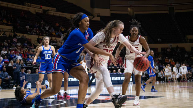 Mar 11, 2022; Kansas City, MO, USA; Oklahoma Sooners guard Taylor Robertson (30) dribbles while defended by Kansas Jayhawks center Taiyanna Jackson (1) in the second half at Municipal Auditorium. Mandatory Credit: Amy Kontras-USA TODAY Sports
