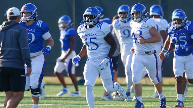Kansas super-senior defensive end Kyron Johnson (15) practices with teammates Tuesday in Lawrence.