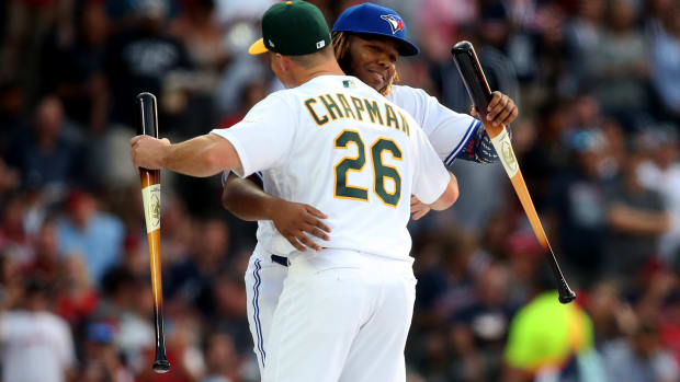 Jul 8, 2019; Cleveland, OH, USA;  American League outfielder Vladimir Guerrero Jr. of the Toronto Blue Jays greets infielder Matt Chapman (26) of the Oakland Athletics before the 2019 MLB Home Run Derby at Progressive Field.