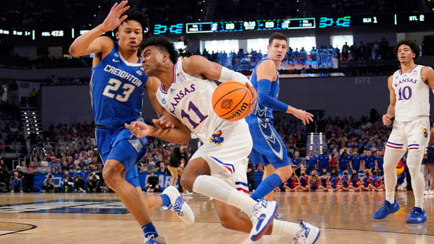 Kansas guard Remy Martin (11) drives to the basket as Creighton guard Trey Alexander (23) defends in the first half of a second-round game in the NCAA college basketball tournament in Fort Worth, Texas, Saturday, March, 19, 2022.