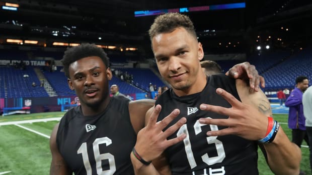 Mar 3, 2022; Indianapolis, IN, USA; Liberty Flames quarterback Malik Willis (left) and Cincinnati Bearcats quarterback Desmond Ridder (QB13) pose during the NFL Scouting Combine at Lucas Oil Stadium.