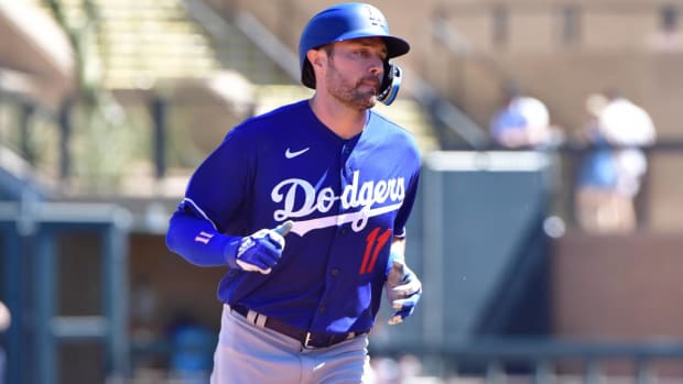 Mar 24, 2022; Salt River Pima-Maricopa, Arizona, USA; Los Angeles Dodgers left fielder AJ Pollock (11) hits a solo home run in the third inning against the Los Angeles Dodgers during spring training at Salt River Fields at Talking Stick.