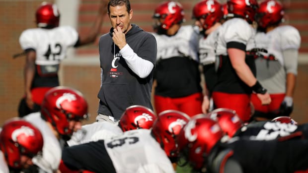 Cincinnati Bearcats head coach Luke Fickell looks over a play during a spring practice at Nippert Stadium in Cincinnati on Thursday, March 24, 2022. Cincinnati Bearcats Spring Practice