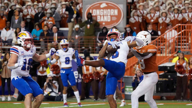 Nov 13, 2021; Austin, Texas, USA; Kansas Jayhawks safety OJ Burroughs (5) intercepts a pass in the end zone intended for Texas Longhorns wide receiver Xavier Worthy (8) in the second half at Darrell K Royal-Texas Memorial Stadium. Mandatory Credit: Scott Wachter-USA TODAY Sports