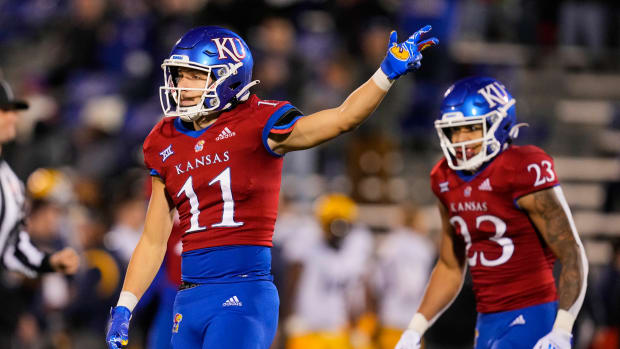 Nov 27, 2021; Lawrence, Kansas, USA; Kansas Jayhawks wide receiver Luke Grimm (11) celebrates after catching a pass as running back Amauri Pesek-Hickson (23) looks on during the first half against the West Virginia Mountaineers at David Booth Kansas Memorial Stadium. Mandatory Credit: Jay Biggerstaff-USA TODAY Sports