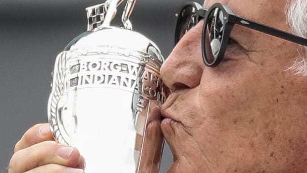 IndyCar legend Mario Andretti kisses a "Baby Borg", a replica of the trophy he won for winning the 1969 Indianapolis 500. Photo: Scott Utterback/For IndyStar-Imagn Content Services, LLC