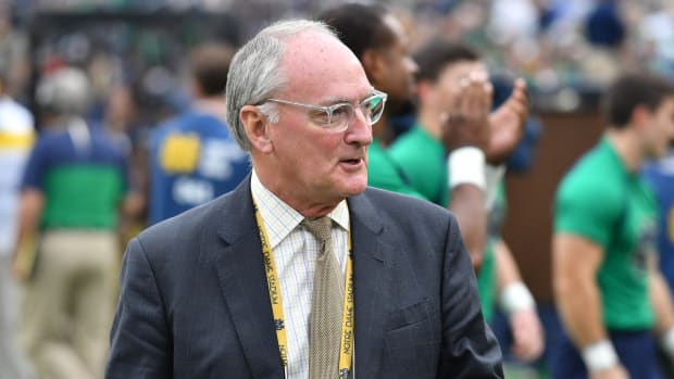 Notre Dame Fighting Irish athletic director Jack Swarbrick walks on the sideline at Notre Dame Stadium during the game between the Notre Dame Fighting Irish and the Virginia Cavaliers.
