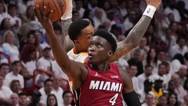 Miami Heat guard Victor Oladipo (4) puts up a shot around Atlanta Hawks forward John Collins (20) during the second half in game five of the first round for the 2022 NBA playoffs at FTX Arena.