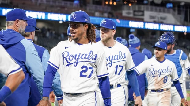 Apr 19, 2022; Kansas City, Missouri, USA; Kansas City Royals shortstop Adalberto Mondesi (27) and first baseman Hunter Dozier (17) and second baseman Nicky Lopez (8) celebrate after the win over the Minnesota Twins at Kauffman Stadium. Mandatory Credit: Denny Medley-USA TODAY Sports