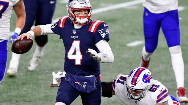 Dec 28, 2020; Foxborough, Massachusetts, USA; New England Patriots quarterback Jarrett Stidham (4) looks to pass under pressure from Buffalo Bills defensive tackle Justin Zimmer (61) during the second half at Gillette Stadium. Mandatory Credit: Brian Fluharty-USA TODAY Sports