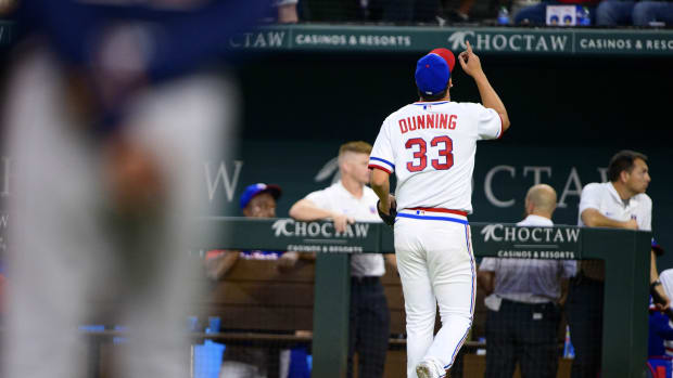 Apr 30, 2022; Arlington, Texas, USA; Texas Rangers starting pitcher Dane Dunning (33) motions to the sky as he leaves the game against the Atlanta Braves during the eighth inning at Globe Life Field.