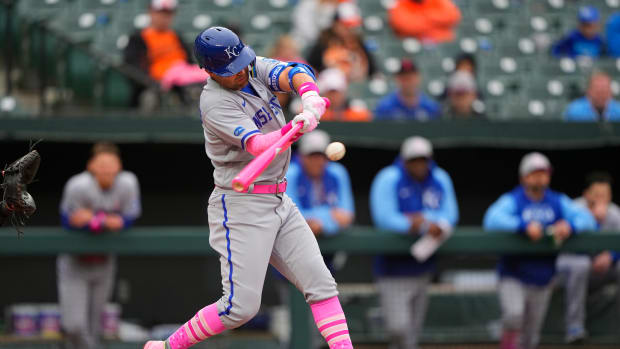 May 8, 2022; Baltimore, Maryland, USA; Kansas City Royals second baseman Whit Merrifield (15) hits a sacrifice fly ball to score a run against the Baltimore Orioles during the second inning at Oriole Park at Camden Yards. Mandatory Credit: Gregory Fisher-USA TODAY Sports