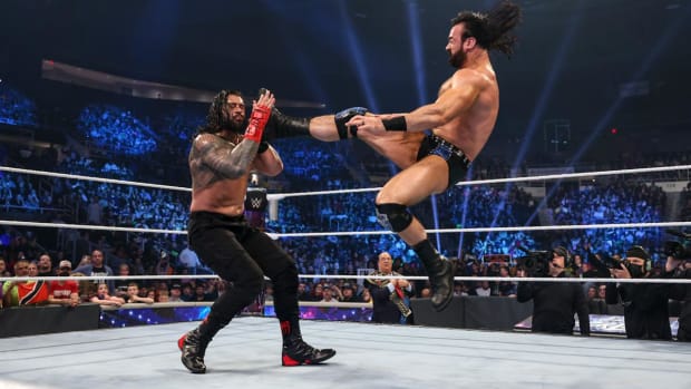 Drew McIntyre delivers a Claymore kick to Roman Reigns