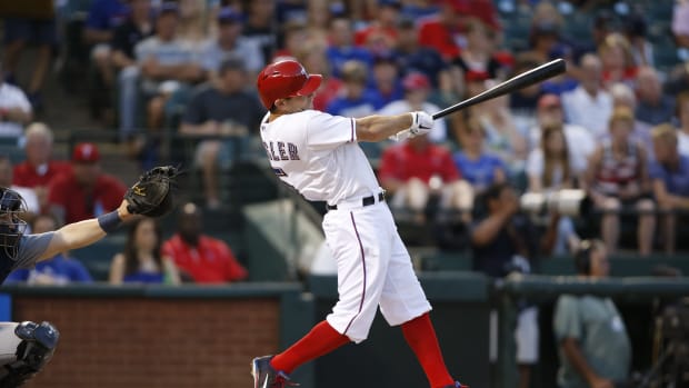 Jul 3, 2013; Arlington, TX, USA; Texas Rangers second baseman Ian Kinsler (5) hits a home run in the fifth inning of the game against the Seattle Mariners at the Rangers Ballpark in Arlington.