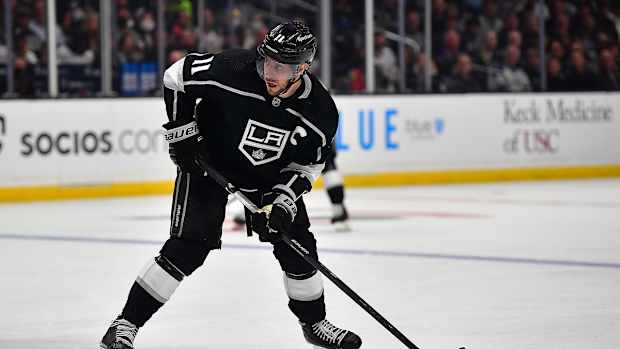 May 12, 2022; Los Angeles, California, USA; Los Angeles Kings center Anze Kopitar (11) controls the puck against the Edmonton Oilers during the second period in game six of the first round of the 2022 Stanley Cup Playoffs at Crypto.com Arena. Mandatory Credit: Gary A. Vasquez-USA TODAY Sports