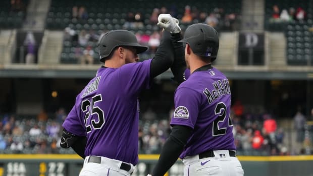 May 21, 2022; Denver, Colorado, USA; Colorado Rockies first baseman C.J. Cron (25) celebrates with second baseman Ryan McMahon (24) after hitting a two run home run against the New York Mets in the first inning at Coors Field. Mandatory Credit: Ron Chenoy-USA TODAY Sports
