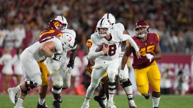 Stanford Cardinal quarterback Tanner McKee (18) carries the ball against the Southern California Trojans in the first half at United Airlines Field at Los Angeles Memorial Coliseum.