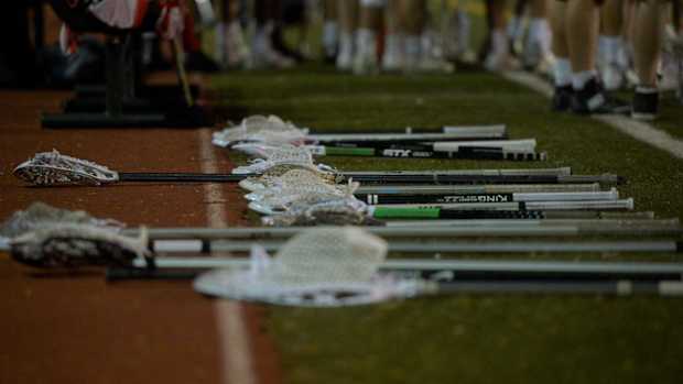 Lacrosse sticks on the ground.