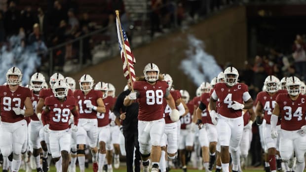 Stanford Cardinal tight end Tucker Fisk (88) runs onto the field with his teammates waving the American flag before the game against the Utah Utes at Stanford Stadium. Mandatory Credit: