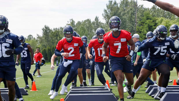 Seattle Seahawks quarterback Geno Smith (7) and quarterback Drew Lock (2) participate in a drill during an OTA workout at the Virginia Mason Athletic Center.